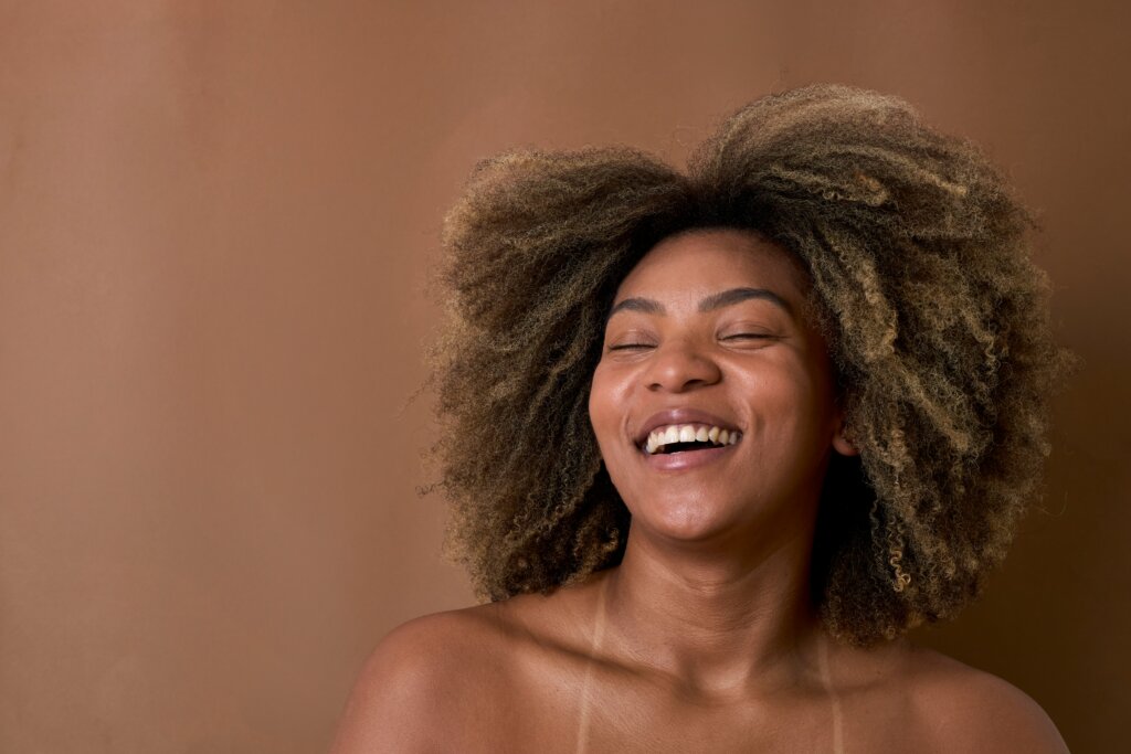 Black woman smiling via Lau Baldo/Unsplash for the love evolution of nigerian women