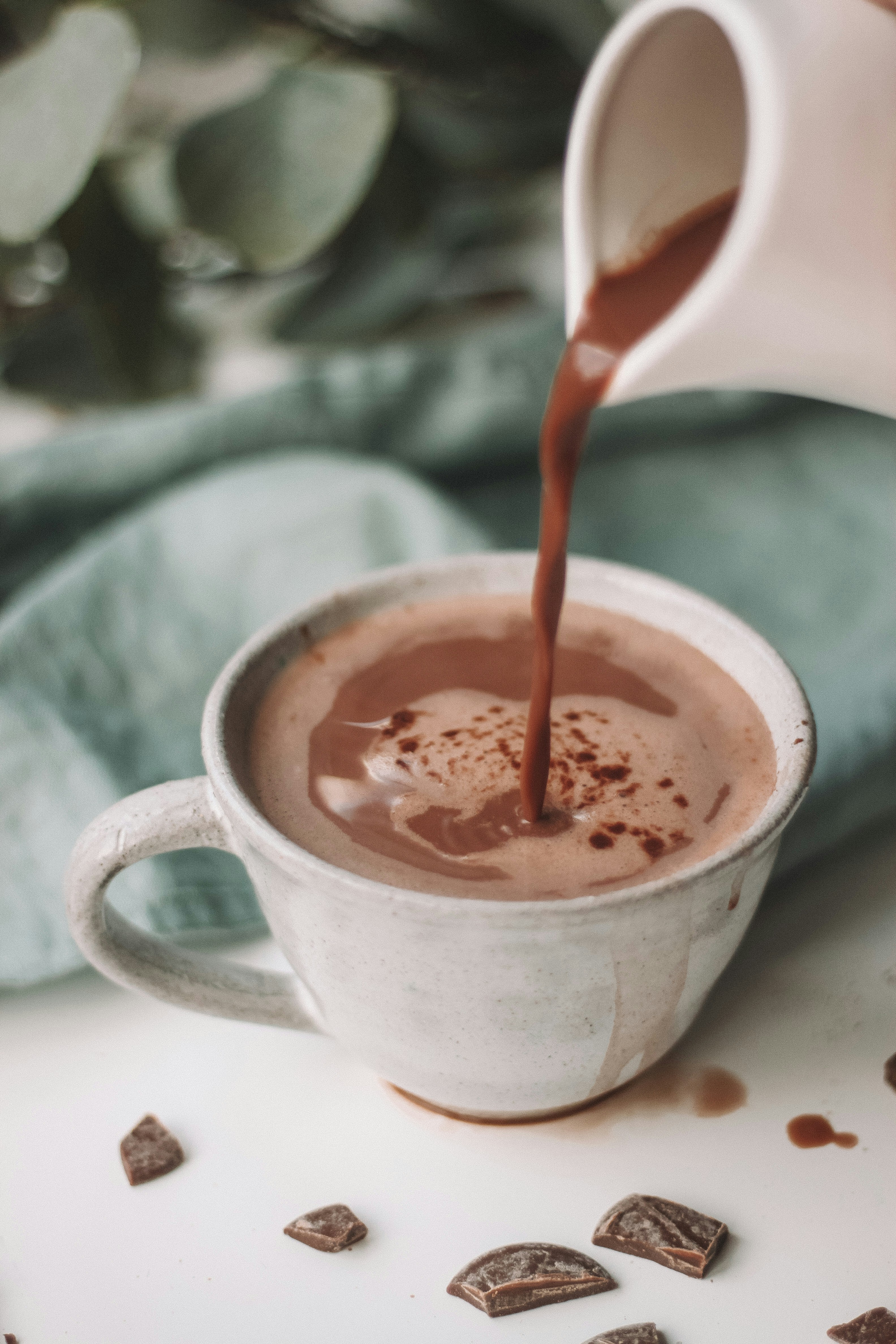 A cup of cocoa being poured by Maddi Bazzocco via Unsplash +