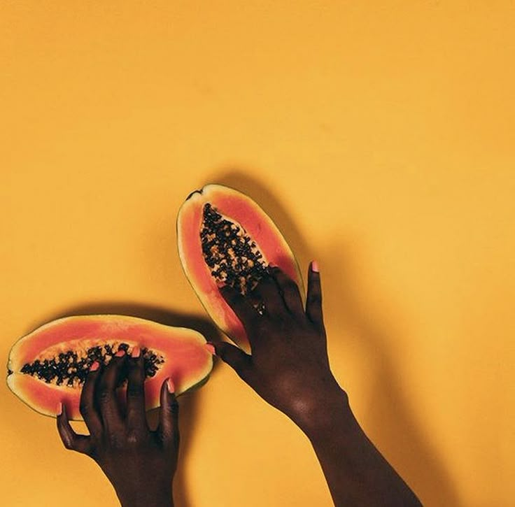 Hands dipped in two cuts of papaya via Pinterest