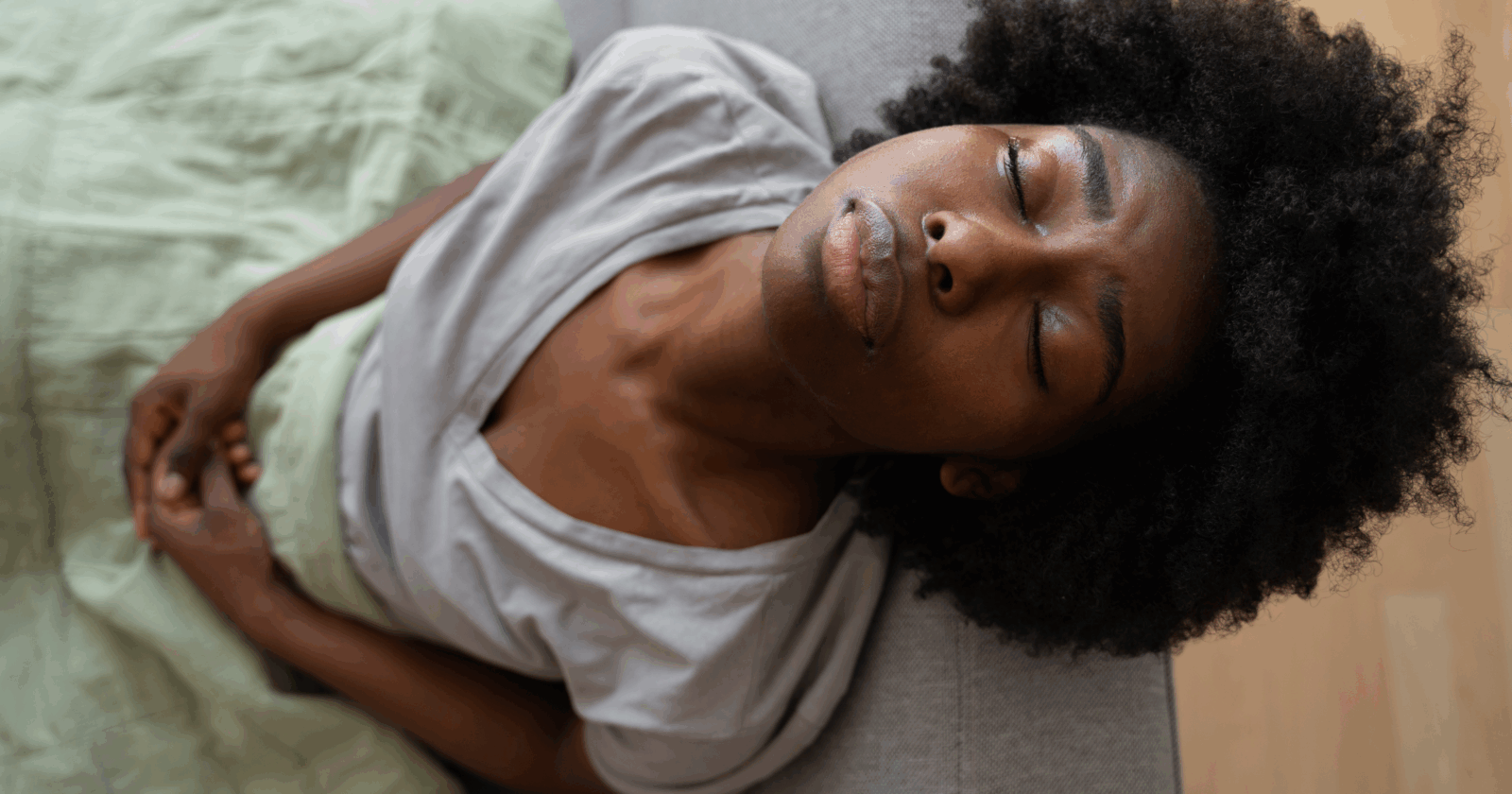 Black woman experiencing discomfort via Freepik