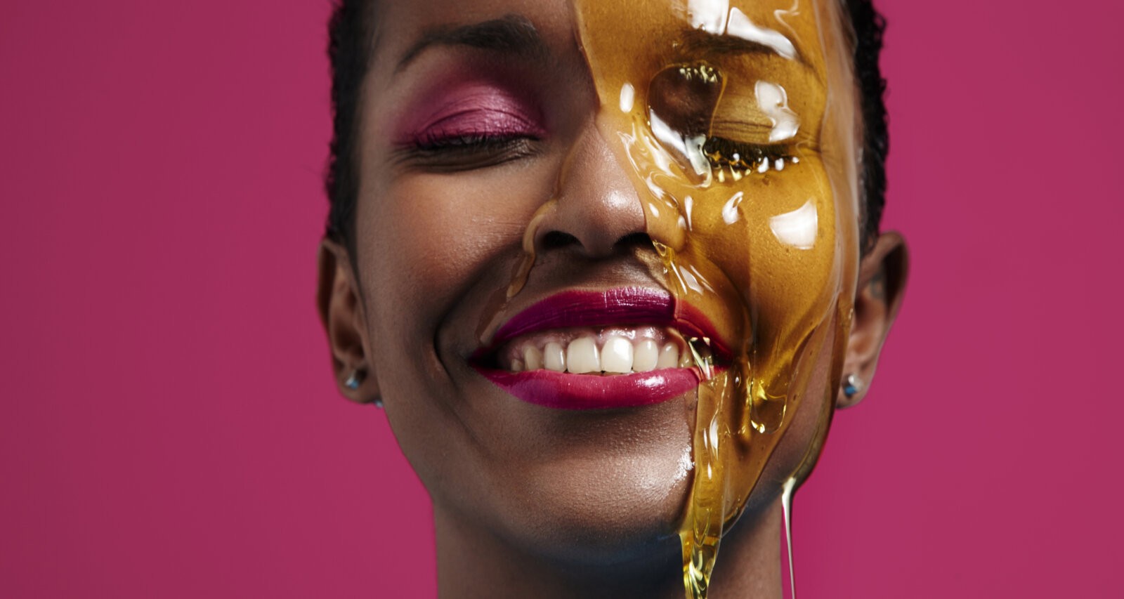 A black woman with honesy running down her face via Freepik