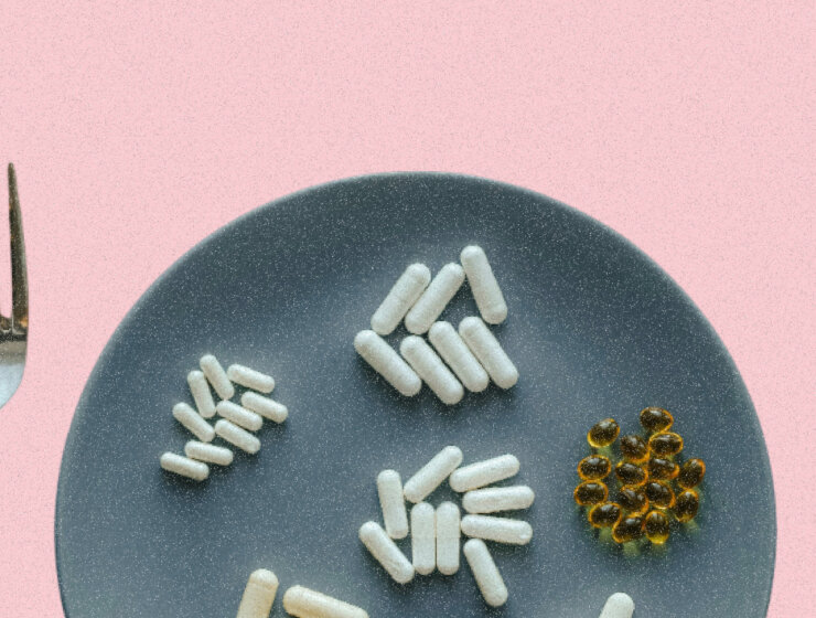 A plate containing a spread of supplements, flanked on either side by a knife and fork via Unsplash