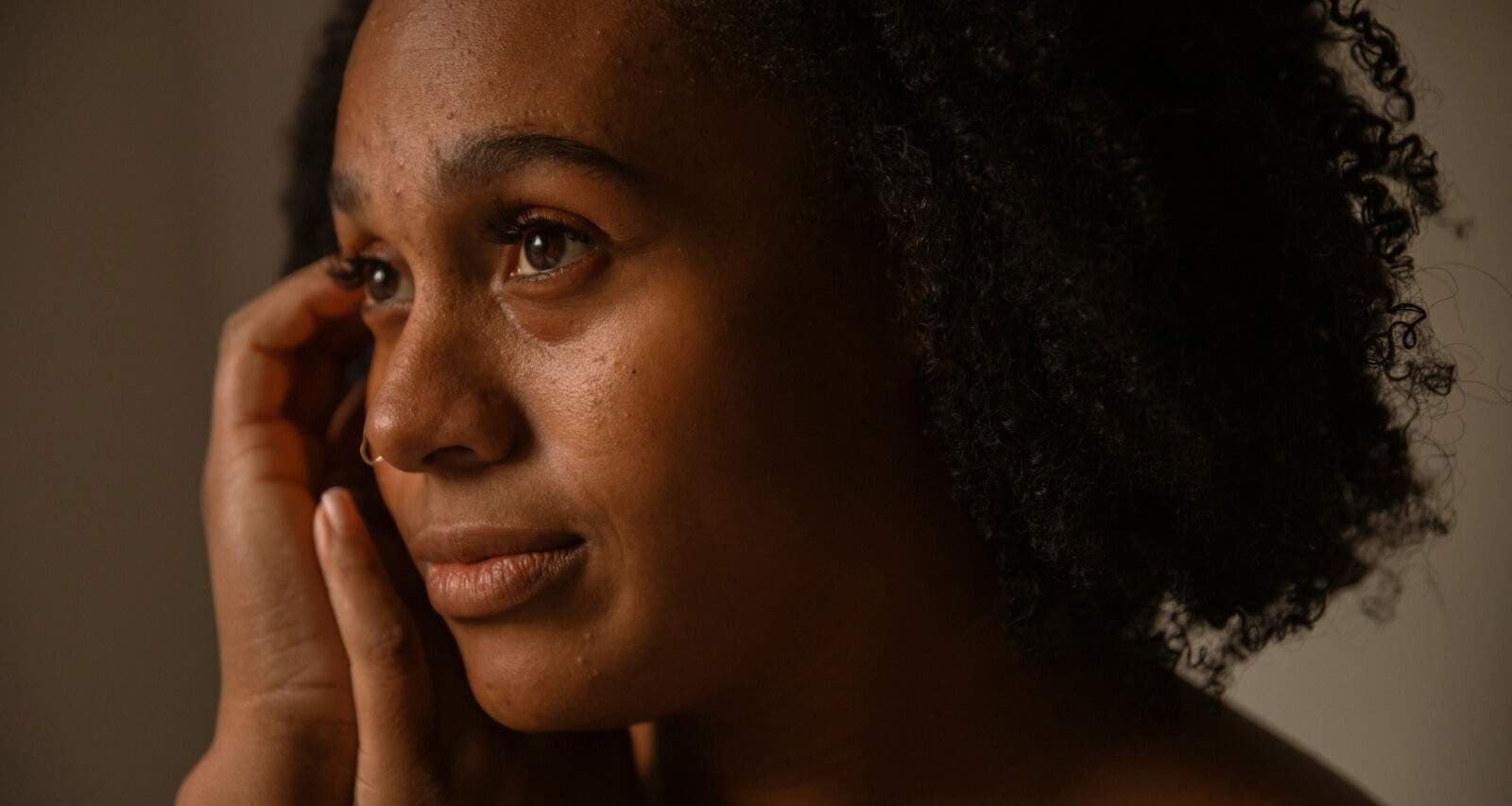 A close-up shot black woman with regular skin via Pablo Merchan Motes via unsplash