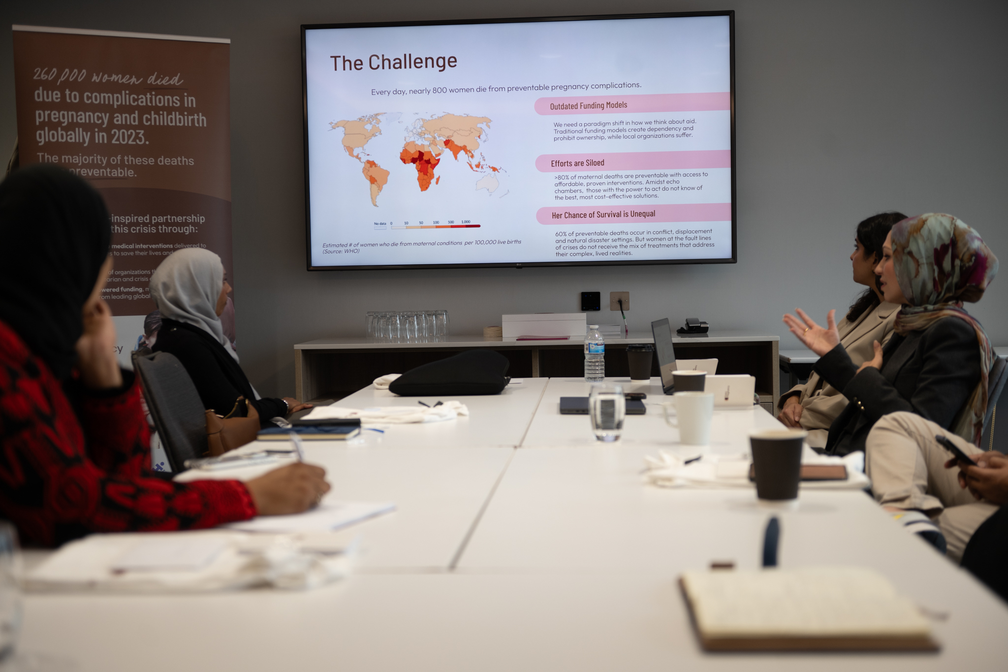 A photograph of Isra Chaker in a group meeting via Isra Chaker