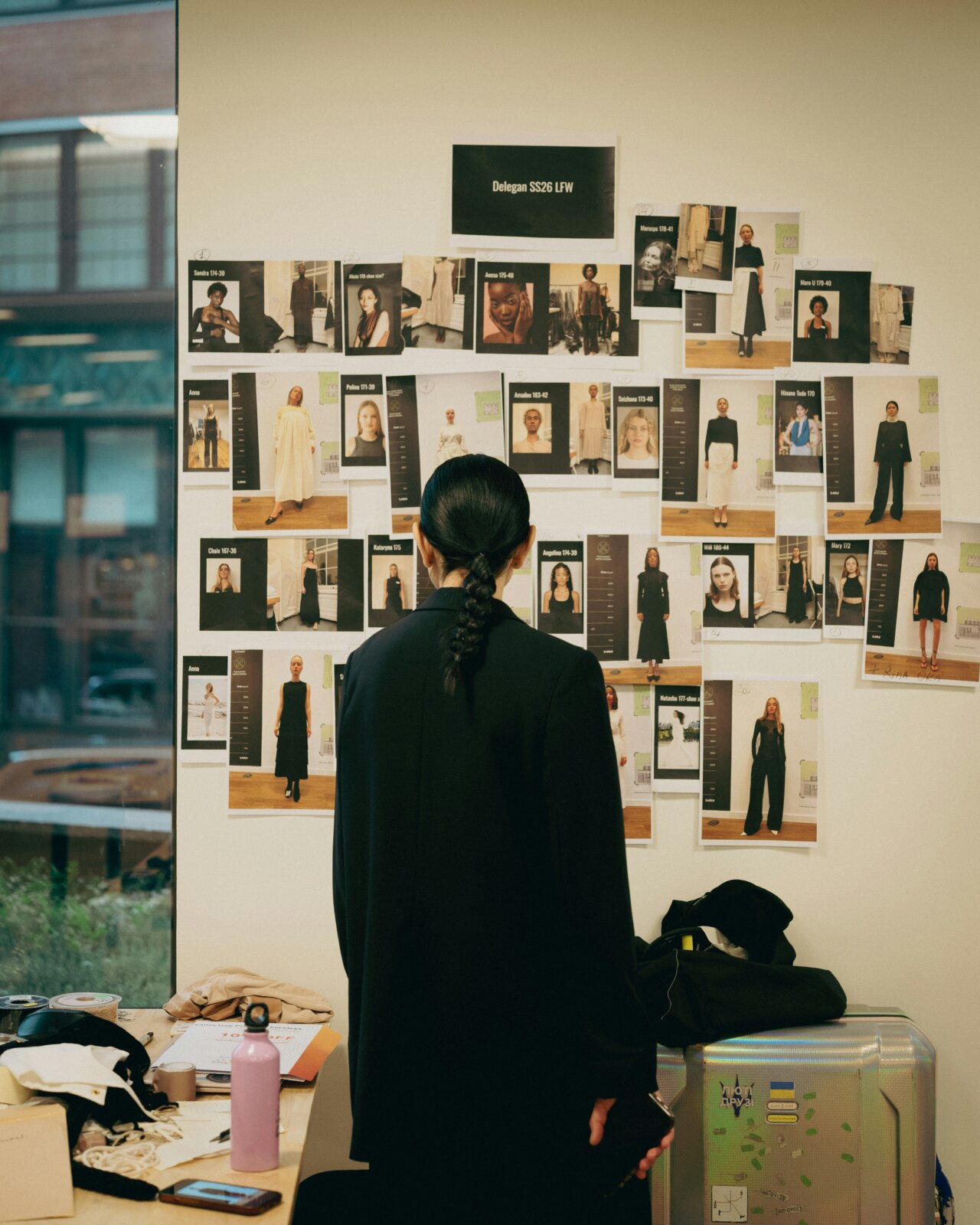 Woman standing in front of a fashion moodboard by Metin Ozer via Unsplash