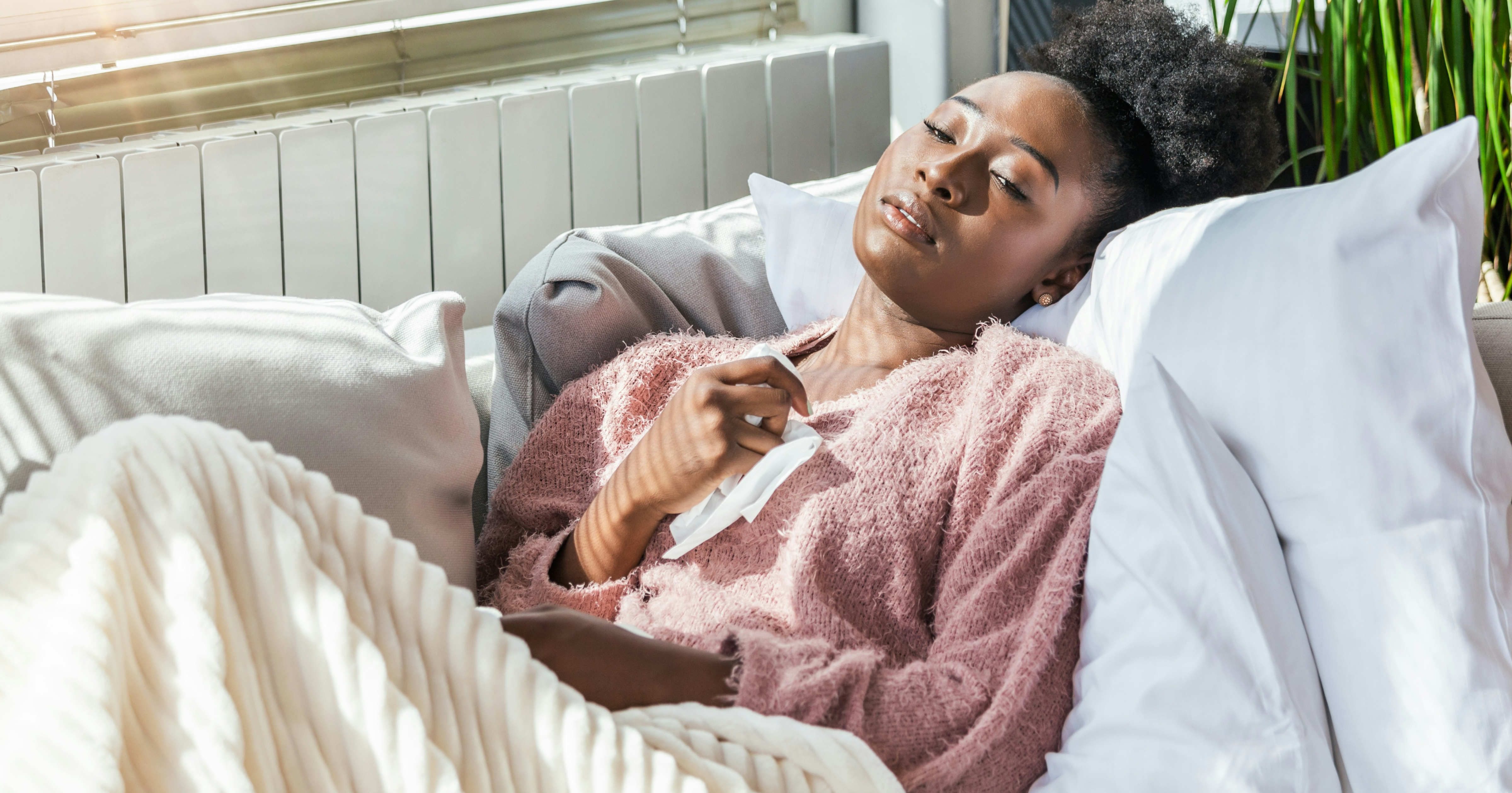A black woman in bed via Unsplash