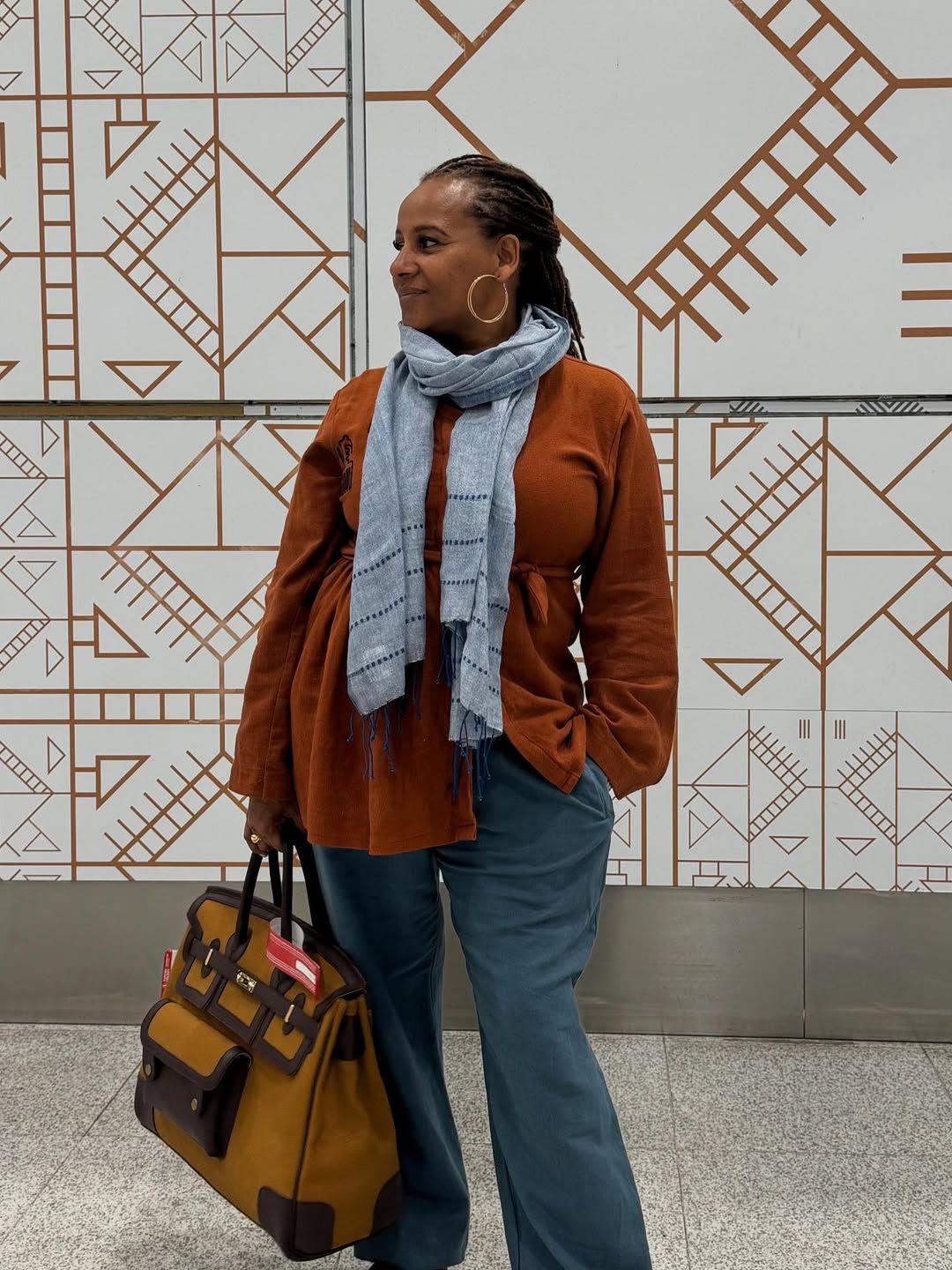 Mahlet Teklemariam in a brown sweater and Blue scarf