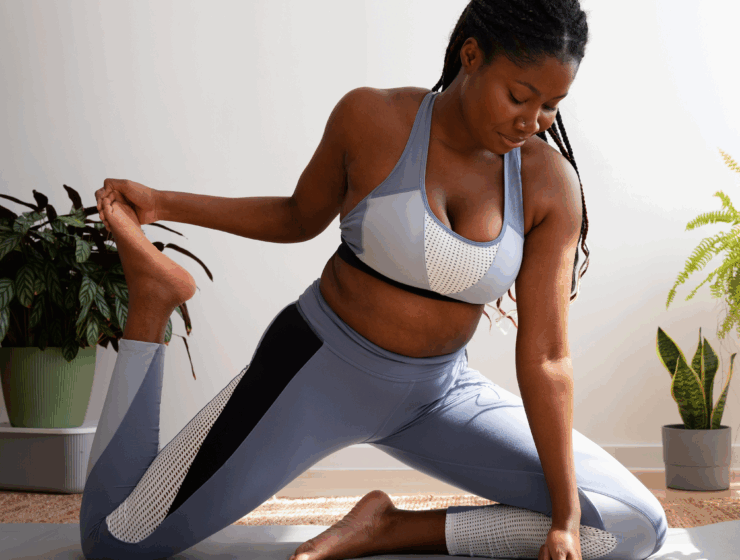 A black woman practising Yoga via Freepik